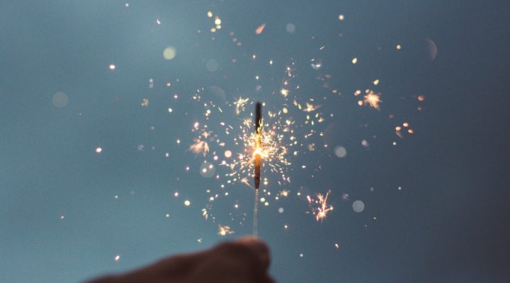 person holding lighted sparklers